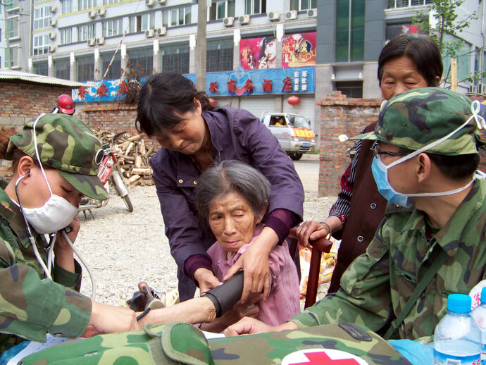 Women getting blood pressure checked by Chinese army