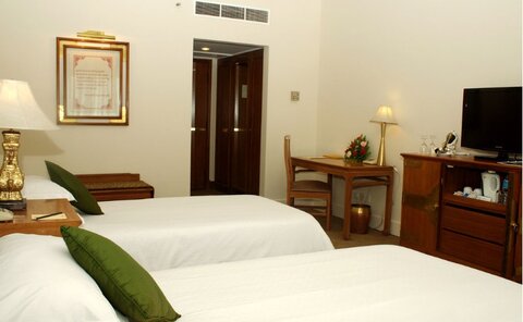 Deluxe room | Decorated in gentle shades of peach and pale yellow, this spacious room features Nepalese antique art pieces Deluxe room | Decorated in gentle shades of peach and pale yellow, this spacious room features Nepalese antique art pieces